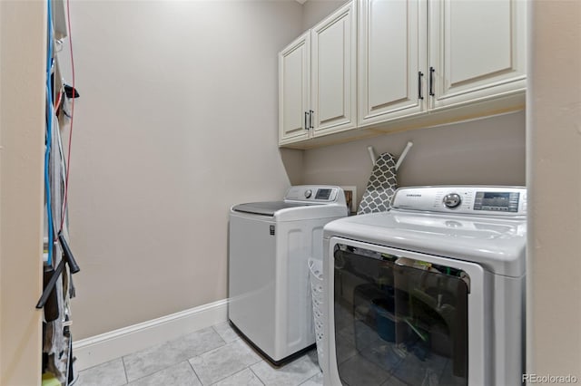 29303 E 165th Ave, Brighton, CO 80603 - laundry room featuring washer and clothes dryer, cabinet space, and light tile patterned flooring