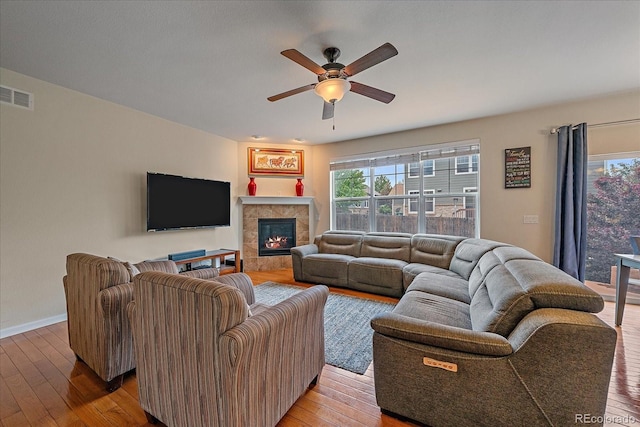 6461 S Ider St, Aurora, CO 80016 - living area featuring hardwood / wood-style floors, ceiling fan, a fireplace, and baseboards