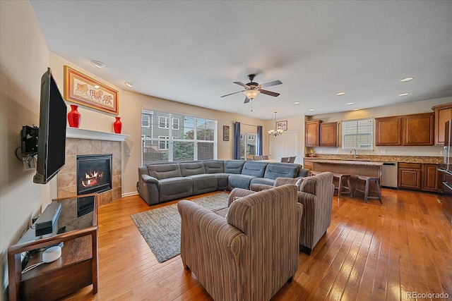 6461 S Ider St, Aurora, CO 80016 - living area featuring a ceiling fan, a fireplace, light wood finished floors, and recessed lighting