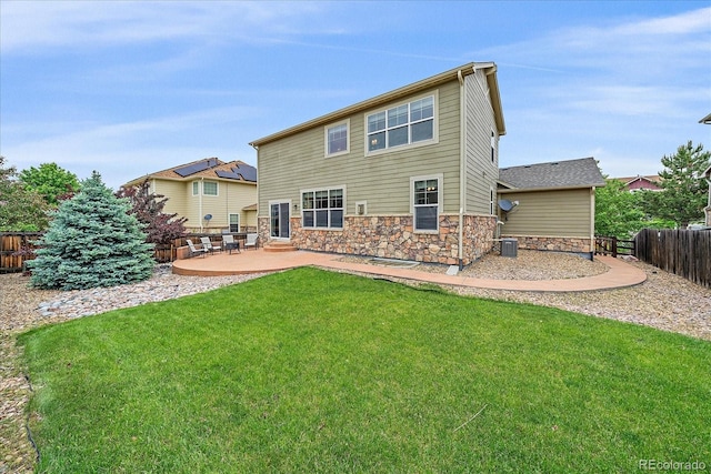 6461 S Ider St, Aurora, CO 80016 - back of property featuring a patio area, stone siding, and cooling unit
