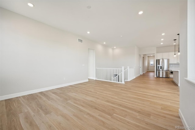 unfurnished room with light hardwood / wood-style floors