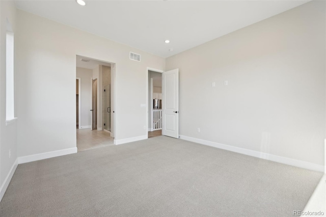 unfurnished bedroom with light colored carpet