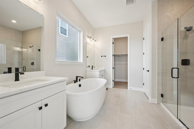 bathroom featuring tile patterned flooring, vanity, and separate shower and tub