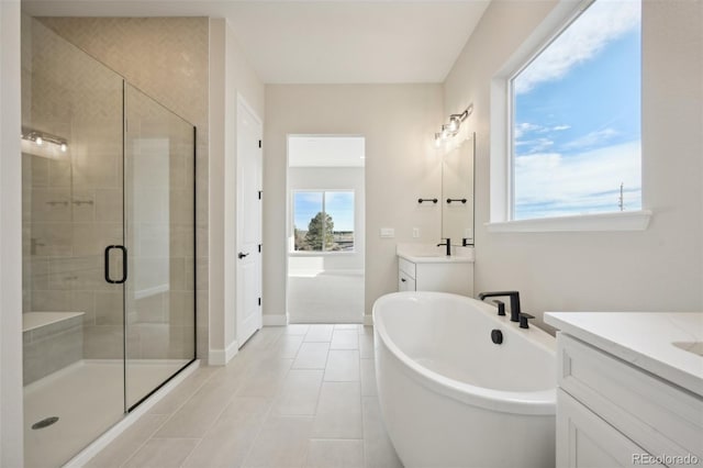 bathroom featuring tile patterned flooring, vanity, and plus walk in shower