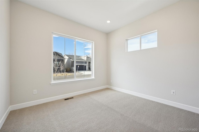 spare room featuring carpet floors and a healthy amount of sunlight