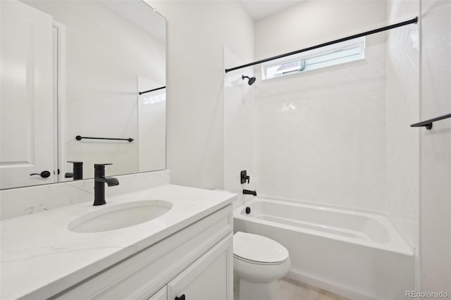 full bathroom with vanity, tiled shower / bath combo, and toilet