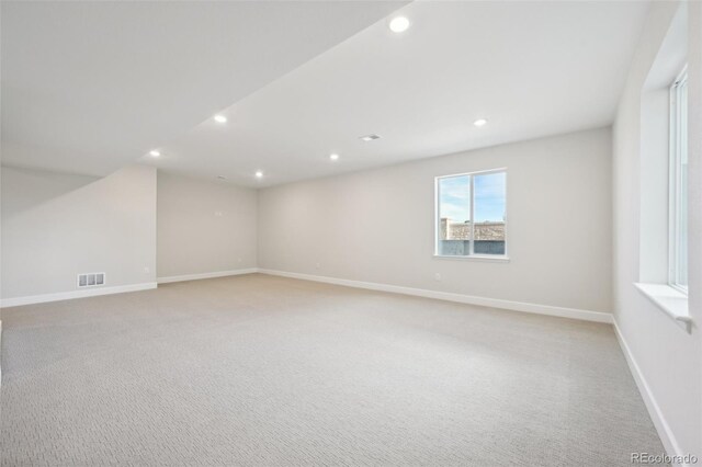 unfurnished room with light colored carpet