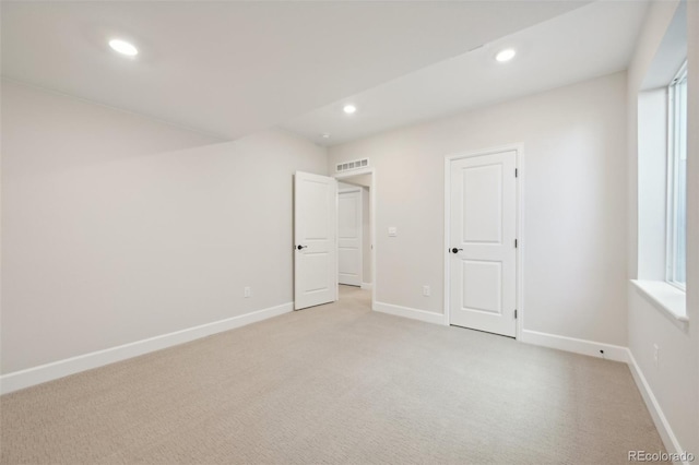 unfurnished bedroom with light colored carpet