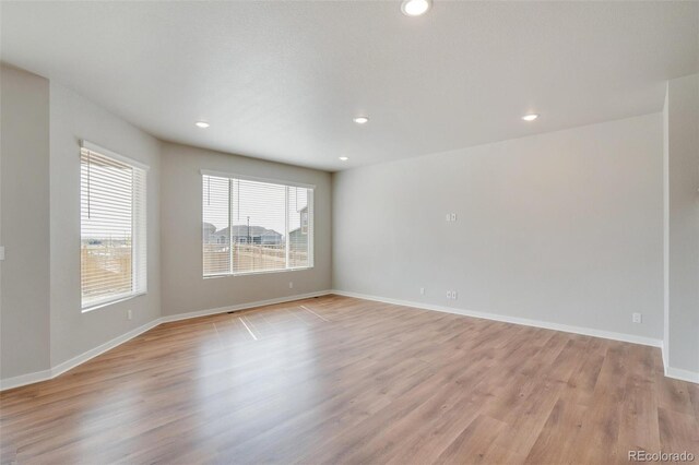 954 Plum Creek Ct, Brighton, CO 80601 - empty room with light wood-style floors and recessed lighting