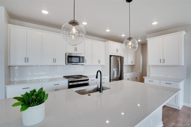 954 Plum Creek Ct, Brighton, CO 80601 - kitchen with stainless steel appliances, decorative backsplash, dark wood-style floors, white cabinetry, and pendant lighting