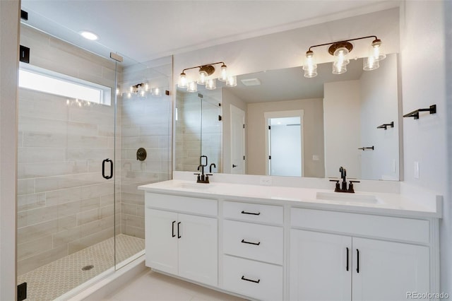 bathroom with vanity and a shower with door