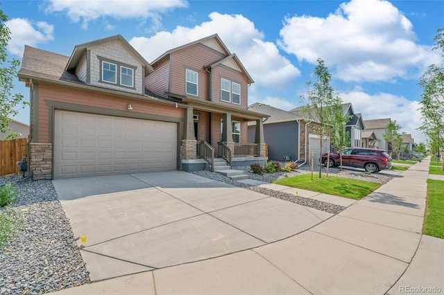 954 Plum Creek Ct, Brighton, CO 80601 - craftsman-style house featuring covered porch, driveway, stone siding, and a residential view