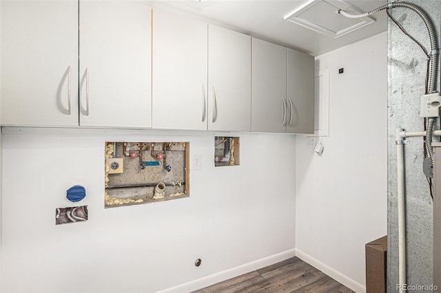 clothes washing area featuring cabinets, washer hookup, and dark hardwood / wood-style flooring