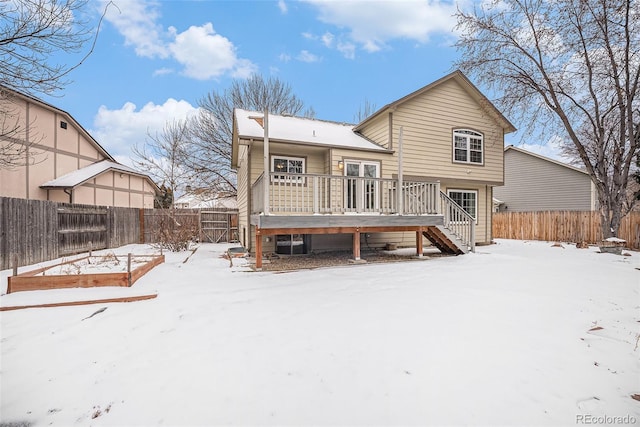 snow covered property featuring a wooden deck