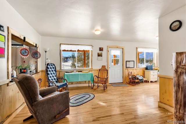 sitting room featuring wood walls and light hardwood / wood-style flooring