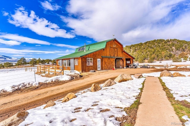 68600 State Highway 69, Westcliffe, CO 81252 - view of snow covered exterior featuring a barn, an outbuilding, and a metal roof