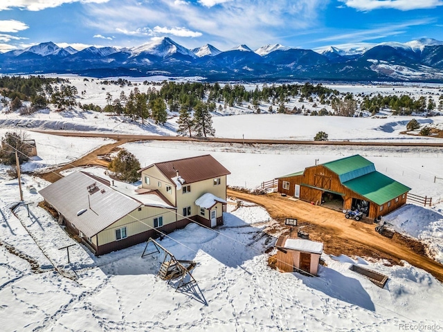 snowy aerial view with a mountain view