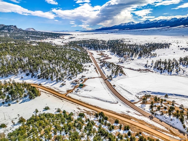 snowy aerial view featuring a mountain view