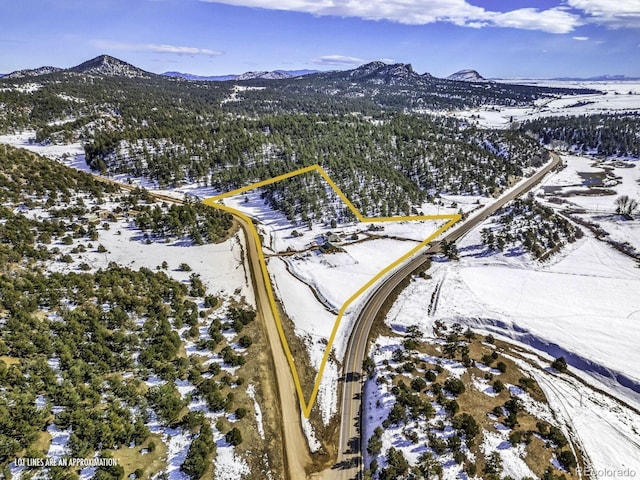 snowy aerial view with a mountain view