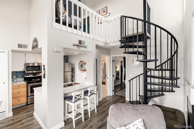 8311 S Upham Way Unit 1-207, Littleton, CO 80128 - staircase with a high ceiling and wood finished floors