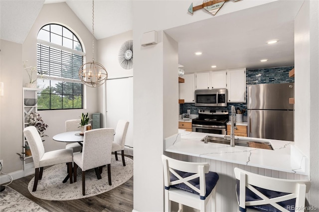 8311 S Upham Way Unit 1-207, Littleton, CO 80128 - dining area featuring dark wood-type flooring, a chandelier, lofted ceiling, and recessed lighting