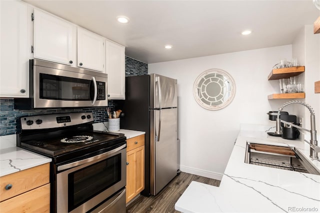 8311 S Upham Way Unit 1-207, Littleton, CO 80128 - kitchen featuring appliances with stainless steel finishes, open shelves, dark wood-type flooring, light stone countertops, and white cabinetry
