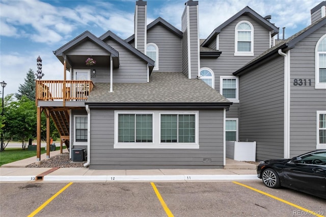 8311 S Upham Way Unit 1-207, Littleton, CO 80128 - view of front facade with uncovered parking and roof with shingles
