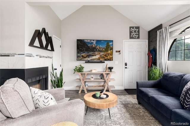 8311 S Upham Way Unit 1-207, Littleton, CO 80128 - living room with wood finished floors, vaulted ceiling, and a fireplace