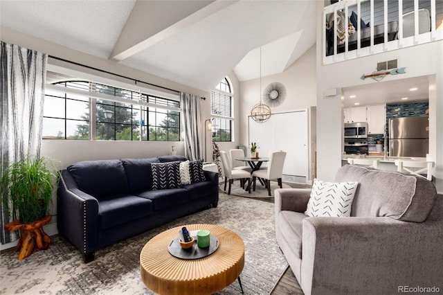 8311 S Upham Way Unit 1-207, Littleton, CO 80128 - living room featuring a chandelier, wood finished floors, and high vaulted ceiling