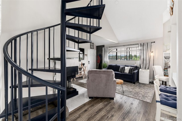 8311 S Upham Way Unit 1-207, Littleton, CO 80128 - living room with high vaulted ceiling, stairway, and wood finished floors