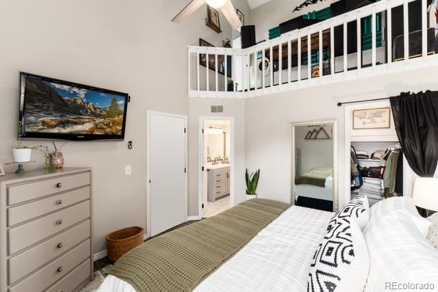 8311 S Upham Way Unit 1-207, Littleton, CO 80128 - bedroom featuring a towering ceiling and ensuite bath