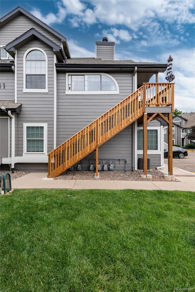 8311 S Upham Way Unit 1-207, Littleton, CO 80128 - back of house with a lawn, a chimney, and a deck