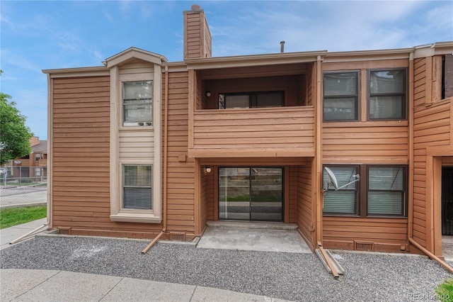 4283 S Salida Way Unit 8, Aurora, CO 80013 - rear view of property with a balcony and a chimney