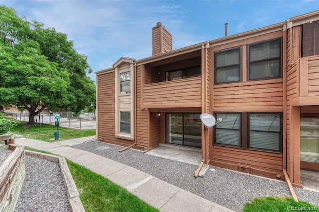 4283 S Salida Way Unit 8, Aurora, CO 80013 - back of property featuring a balcony, a chimney, and crawl space