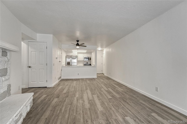 4283 S Salida Way Unit 8, Aurora, CO 80013 - unfurnished living room featuring wood finished floors and ceiling fan