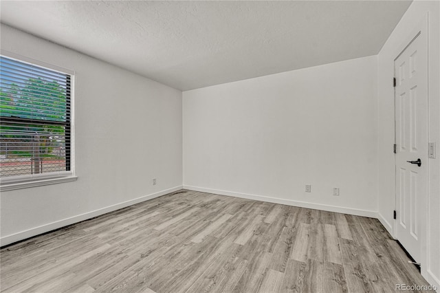 4283 S Salida Way Unit 8, Aurora, CO 80013 - unfurnished room with light wood-style floors and a textured ceiling