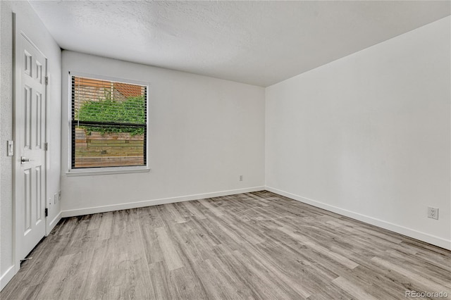 4283 S Salida Way Unit 8, Aurora, CO 80013 - unfurnished bedroom featuring wood finished floors and a textured ceiling
