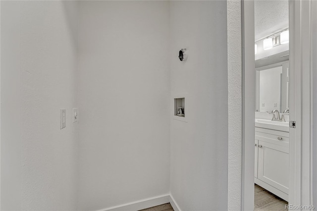 4283 S Salida Way Unit 8, Aurora, CO 80013 - washroom with light wood-style floors and hookup for a washing machine