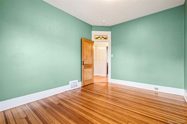 spare room with visible vents, baseboards, and light wood-type flooring