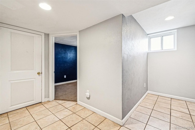 interior space featuring light tile patterned floors, recessed lighting, and baseboards