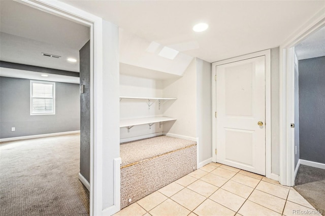 corridor featuring visible vents, baseboards, light colored carpet, recessed lighting, and light tile patterned flooring