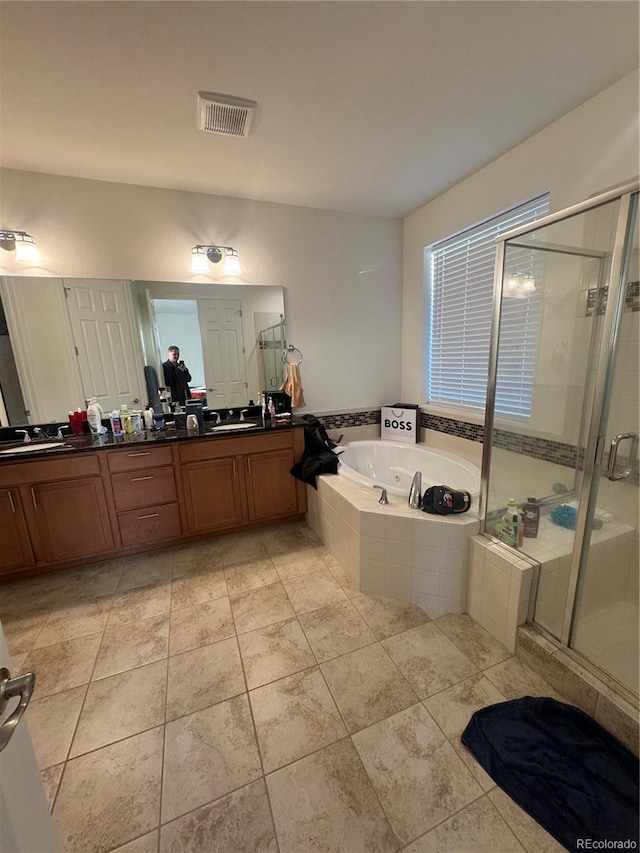 bathroom with vanity, plus walk in shower, and tile patterned flooring