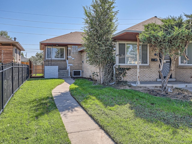 bungalow-style home with a front yard