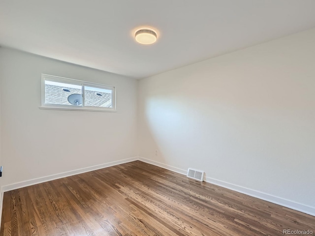 unfurnished room featuring dark hardwood / wood-style flooring