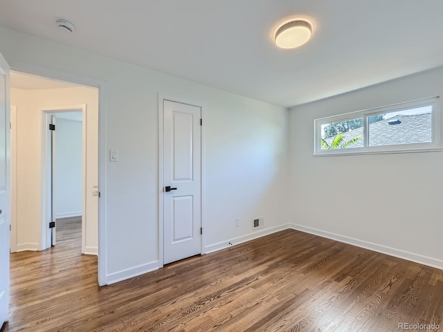 spare room featuring hardwood / wood-style flooring