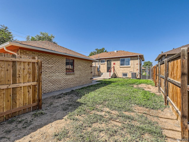 rear view of house with a lawn