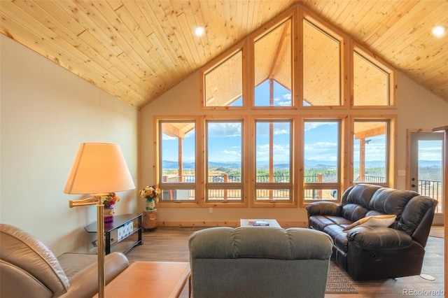 living room with light wood-type flooring, a wealth of natural light, and wooden ceiling