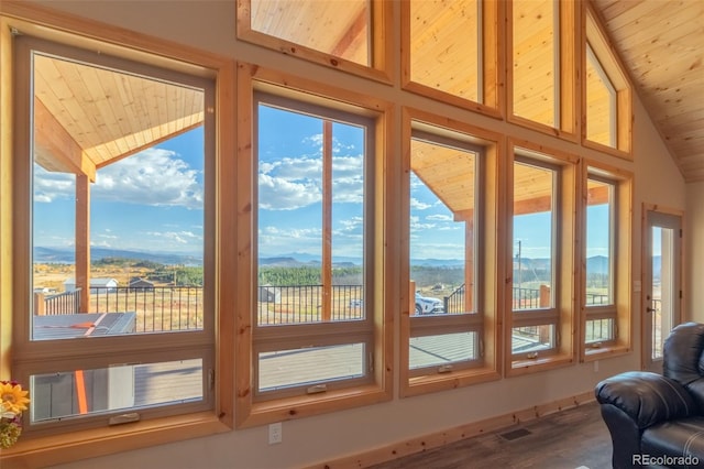 entryway with a mountain view, wood-type flooring, lofted ceiling, and wood ceiling