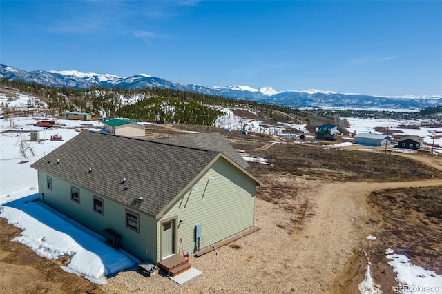 snowy aerial view with a mountain view