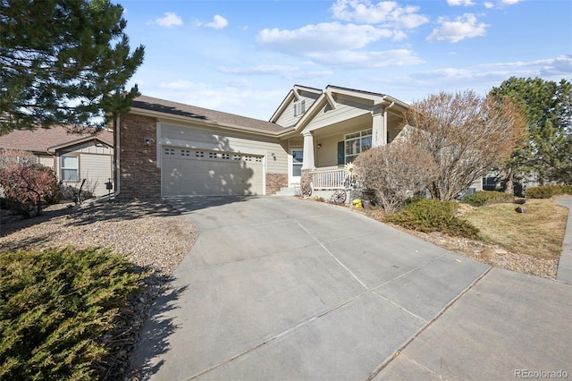 craftsman-style house featuring a garage, concrete driveway, and covered porch